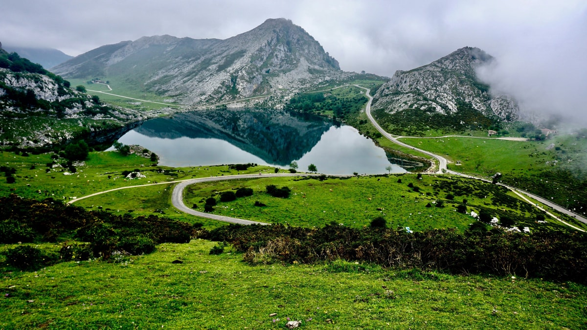 The Lakes of Covadonga among green pasture and the peaks of the Picos de Europa