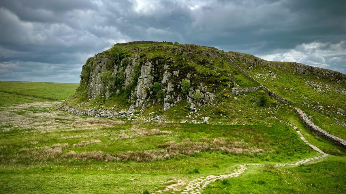 Hadrian's Wall running over a craggy hill near Sycamore Gap